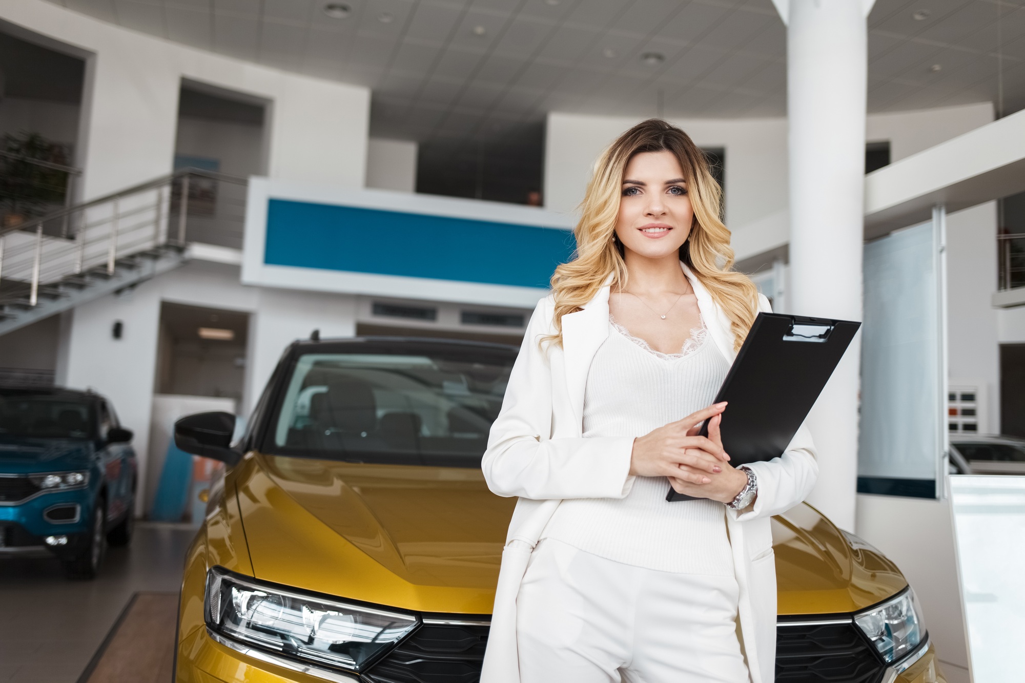 Car sales woman agent at a car dealership