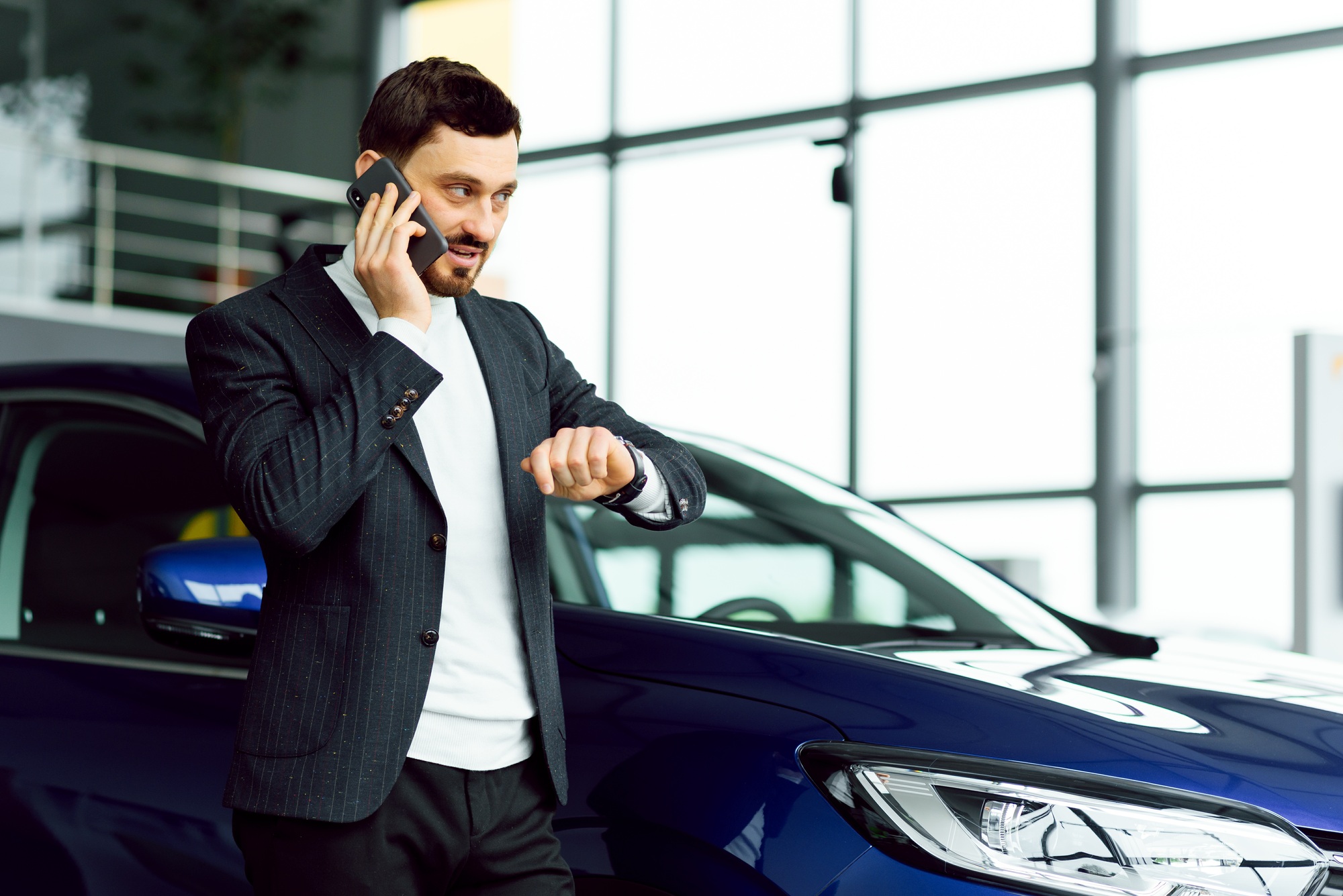 Man buying the car. Businessman in a car salon