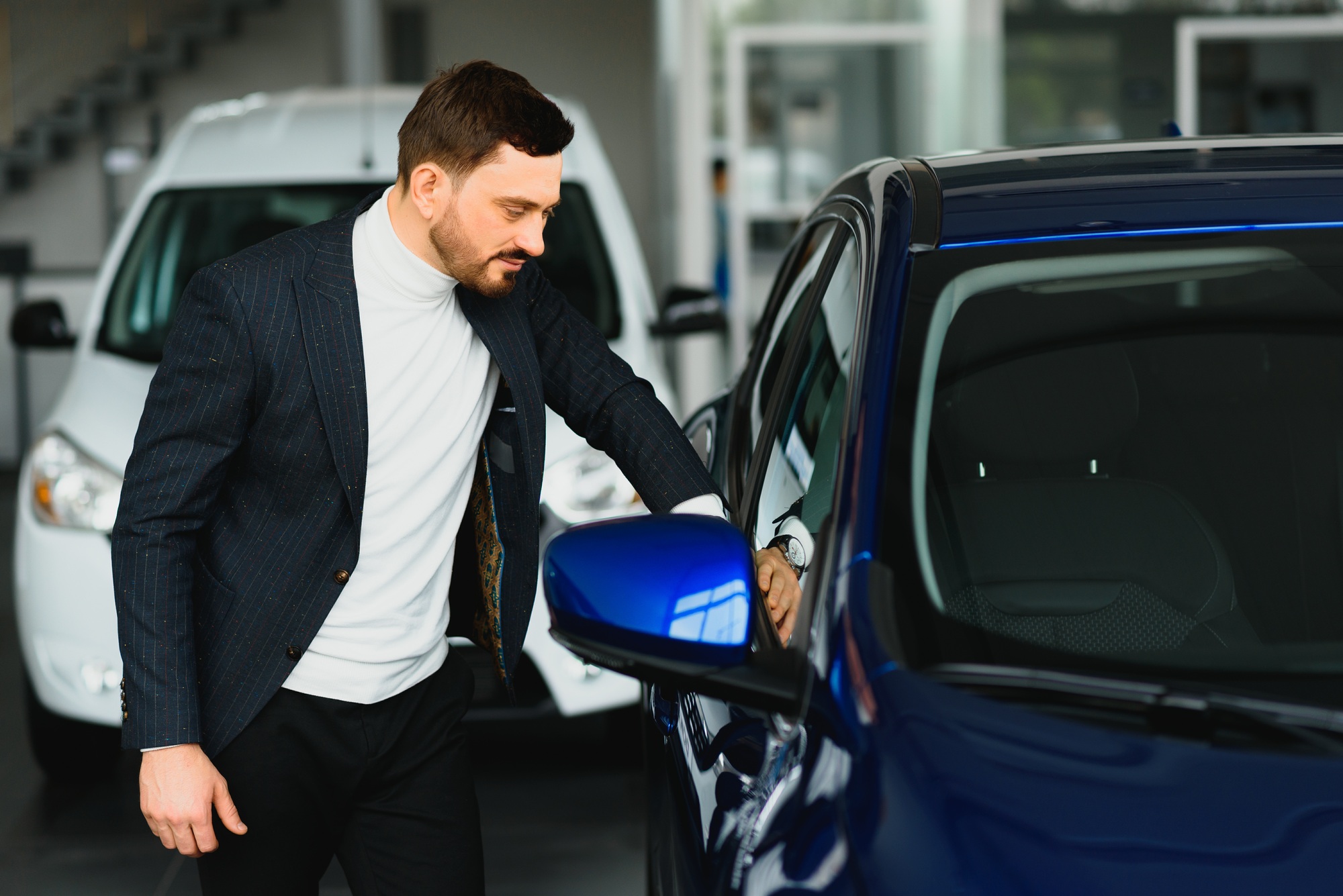 Man buying the car. Businessman in a car salon